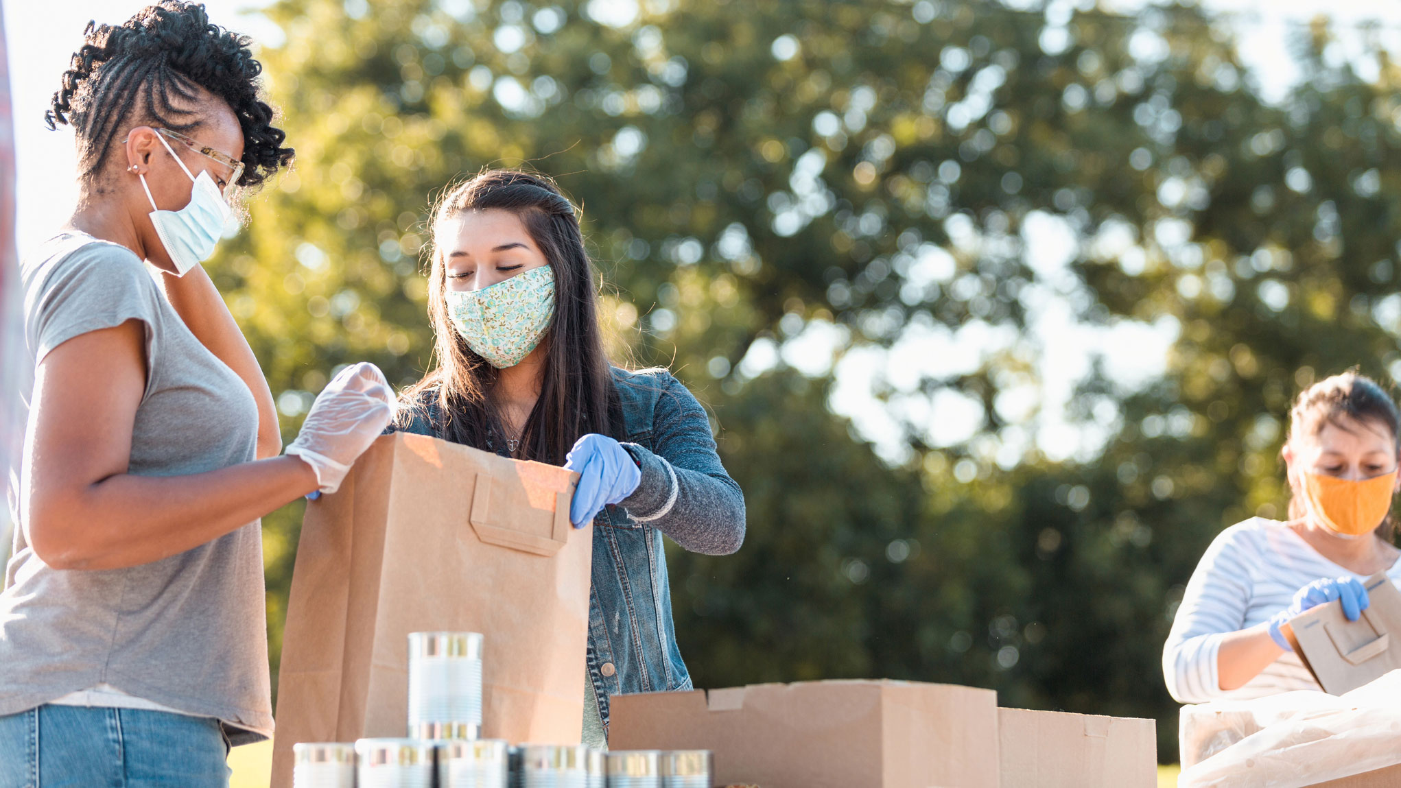 Women filling paper bags at food pantry